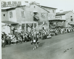 Rex Bell (George Francis Beldam) on horseback in a parade. Stamped on back: Union Pacific Railroad Photo