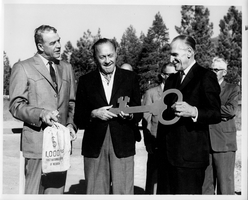 Rex Bell (George Francis Beldam) (right) with two other unidentified people at an unknown location at an event. Stamped on back: Link's Photo Studio, Tribune Building, Al Tahoe, CA