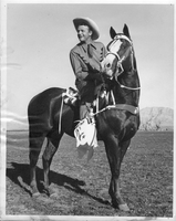 Rex Bell (George Francis Beldam) on horseback at unknown location. Stamped on back: Picture Surveys, Inc., Photo by Schuyler Crail, Not to be used for reproduction without premission of Picture Surveys, Inc, 8440-42, Melrose Ave, Hollywood 46, CA