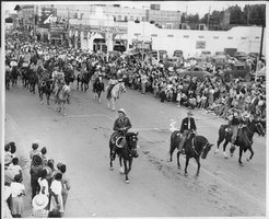 Rex Bell (George Francis Beldam) (front row left) on horseback in a parade.  Jim Cashman and "Sully" Sullivan are also pictured.  Helldorado, 1947. Handwritten on back: Jim Cashman,"Sully" Sullivan.  Helldorado, 1947.  Stamped on back: If used for publication, please credit Gale's Studio, Las Vegas, Nev