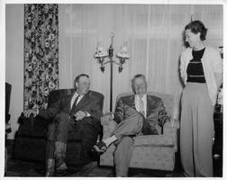 Rex Bell (George Francis Beldam) and Mr. and Mrs. Cramer in their home in Fresno in 1956. Handwritten on back: Fresno, 1956. Mrs. Cramer at their home. Stamped on back: Compliments of Lieutenant Govenor Harold J. Powers, Sacramento, California