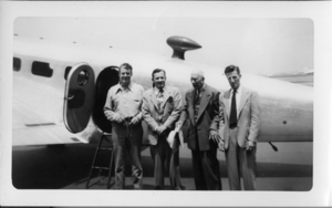 Rex Bell (George Francis Beldam) on left, with three other unidentified people at an unknown location, in front of an airplane