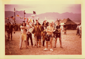 Group of unidentified men dressed as indians in front of a Boy Scout event sign