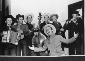 Group of unidentified musicians at unknown location.  On photograph is printed "Photography by Bob Plunkett"