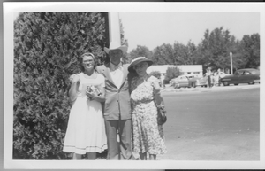 Rex Bell (George Francis Beldam) in Boulder City on July 4, 1955 with two unidentified women. Handwritten on back: July 4, 1955, Boulder City