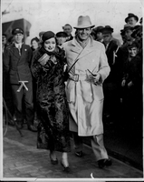 Rex Bell (George Francis Beldam) and Clara Bow while on their trip to Europe with a group of unidentified people. Stamped on back: London News Agency Photos LTD., 46 Fleet St, London, E.C."  May not be reproduced without permission