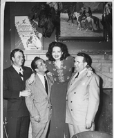 The Thunderbird Hotel, Las Vegas in 1948.  Left to right: Rex Bell (George Frances Beldam), Joey Adams, Clara Bow, Mr. Hicks. Handwritten on back: Thunderbird Hotel, Las Vegas,  Dad, Joey Adams, Mom, Mr. Hicks. 1948
