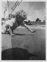 Image of  Rex Anthony Bell, Jr (Toni Larbow Beldam) on a beach at Long Beach, CA in April 1937.  Written on the photograph is "We lived here," other written material is not distinguishable. Handwritten on back: Tony Bell - at Long Beach Calif, April 1937