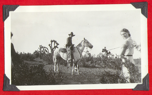 Man on a horse with a woman: photograph