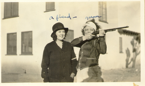 Marion Lewyn, with Clara Bow, aiming the rifle, at Walking Box Ranch: photograph