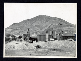 Photograph of workers observing construction in Tonopah or Goldfield (Nev.), early 1900s