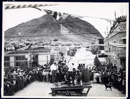 Photograph of a double handed drilling contest in downtown Tonopah (Nev.), early 1900s