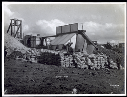 Photograph of workers piling sacks of ore from the Jumbo Mine, Goldfield (Nev.), early 1900s