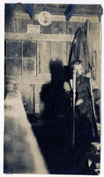 Photograph of a man seated in a wooden building, Goldfield (Nev.), early 1900s