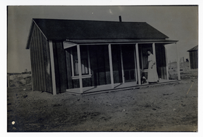 Photograph of Myrta Fenwick on the porch of a miner's cottage, Goldfield (Nev.), early 1900s