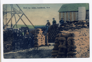 Postcard of men posing with sacked ore at the Red Top Mine, Goldfield (Nev.), 1900-1925