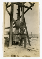 Photograph of a miner working topside filling an ore cart, Goldfield (Nev.), 1907