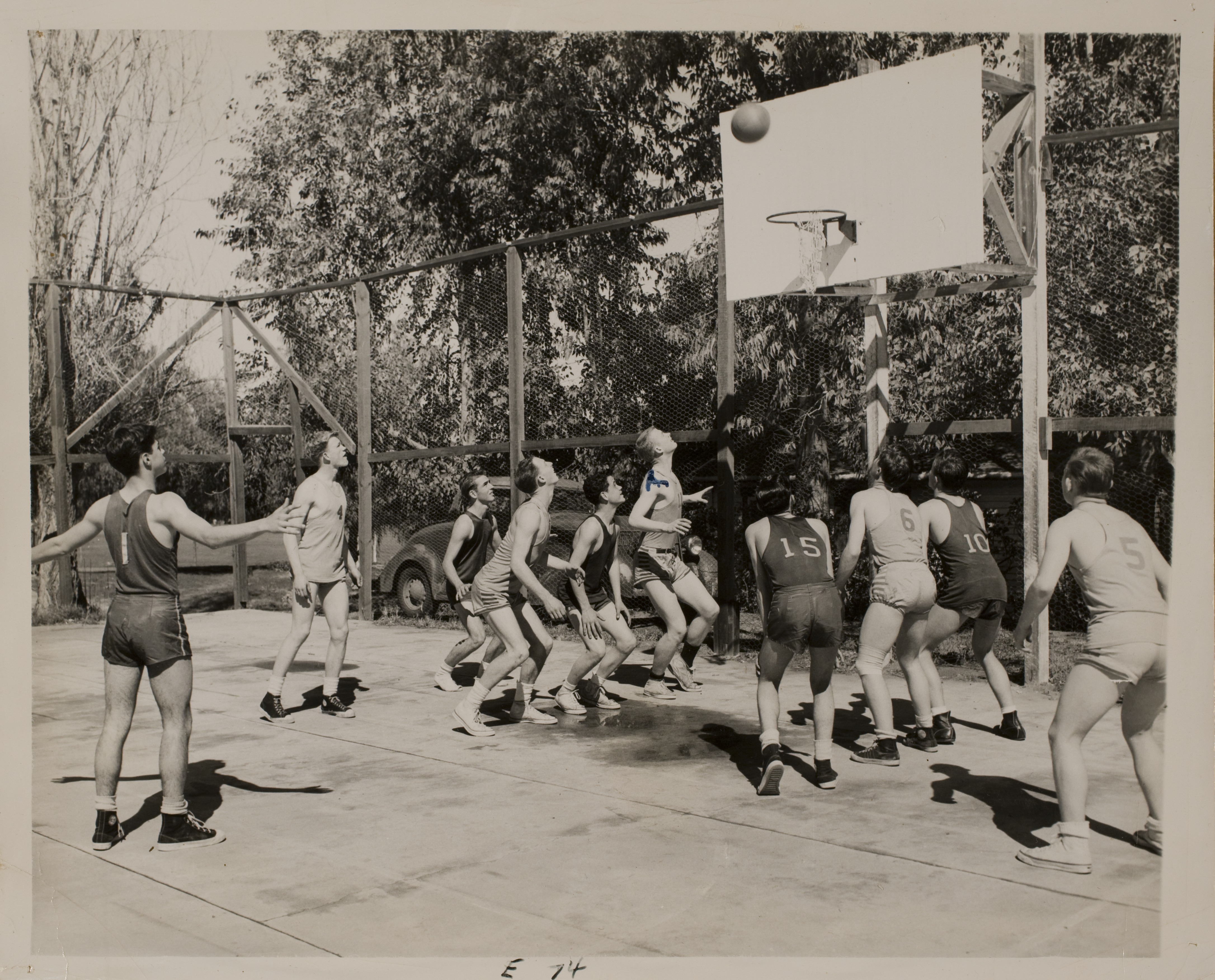 Rex Anthony Bell, Jr. (sixth from the right) playing basketball with other teens: photographic print