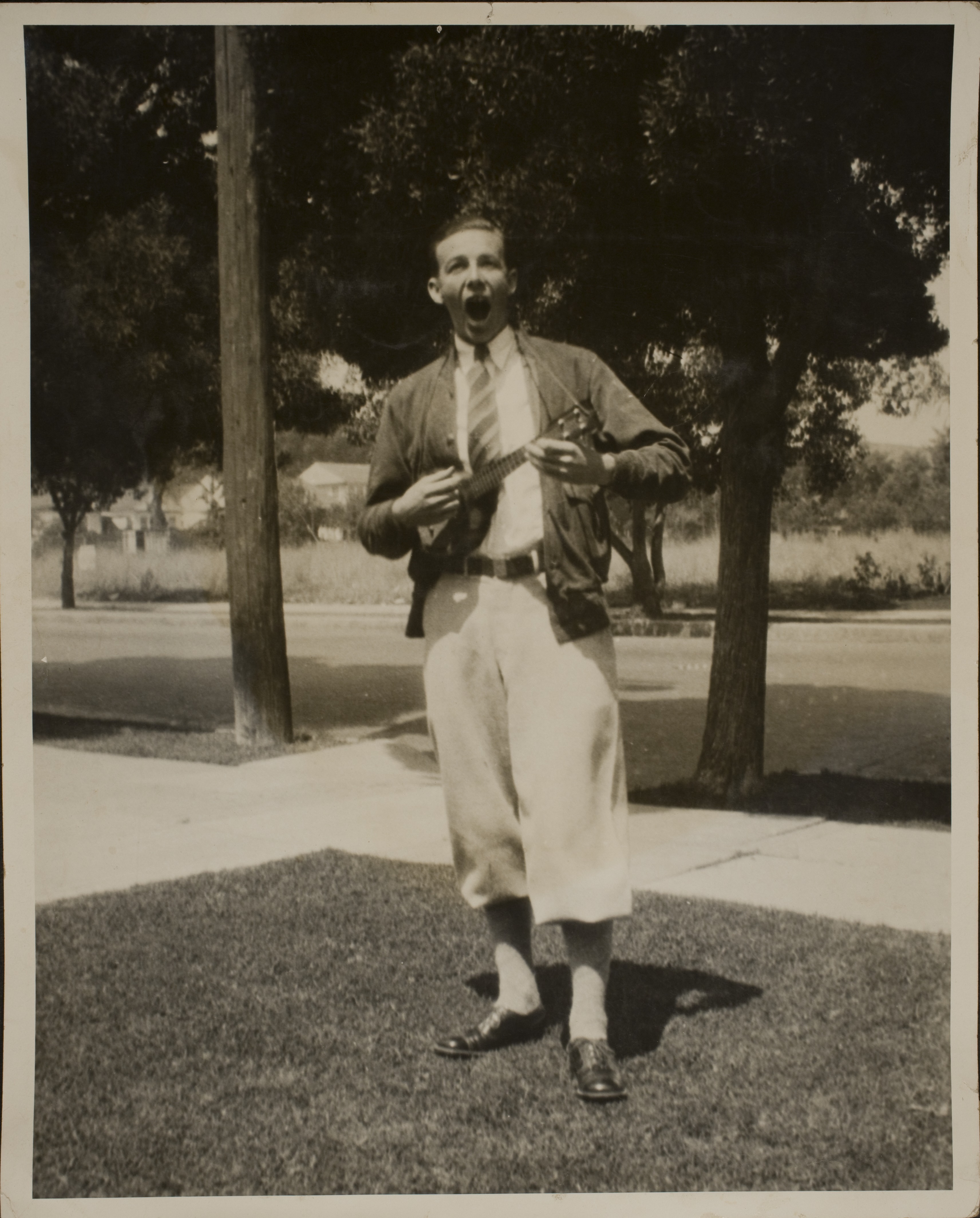 Unidentified man playing ukulele: photographic print