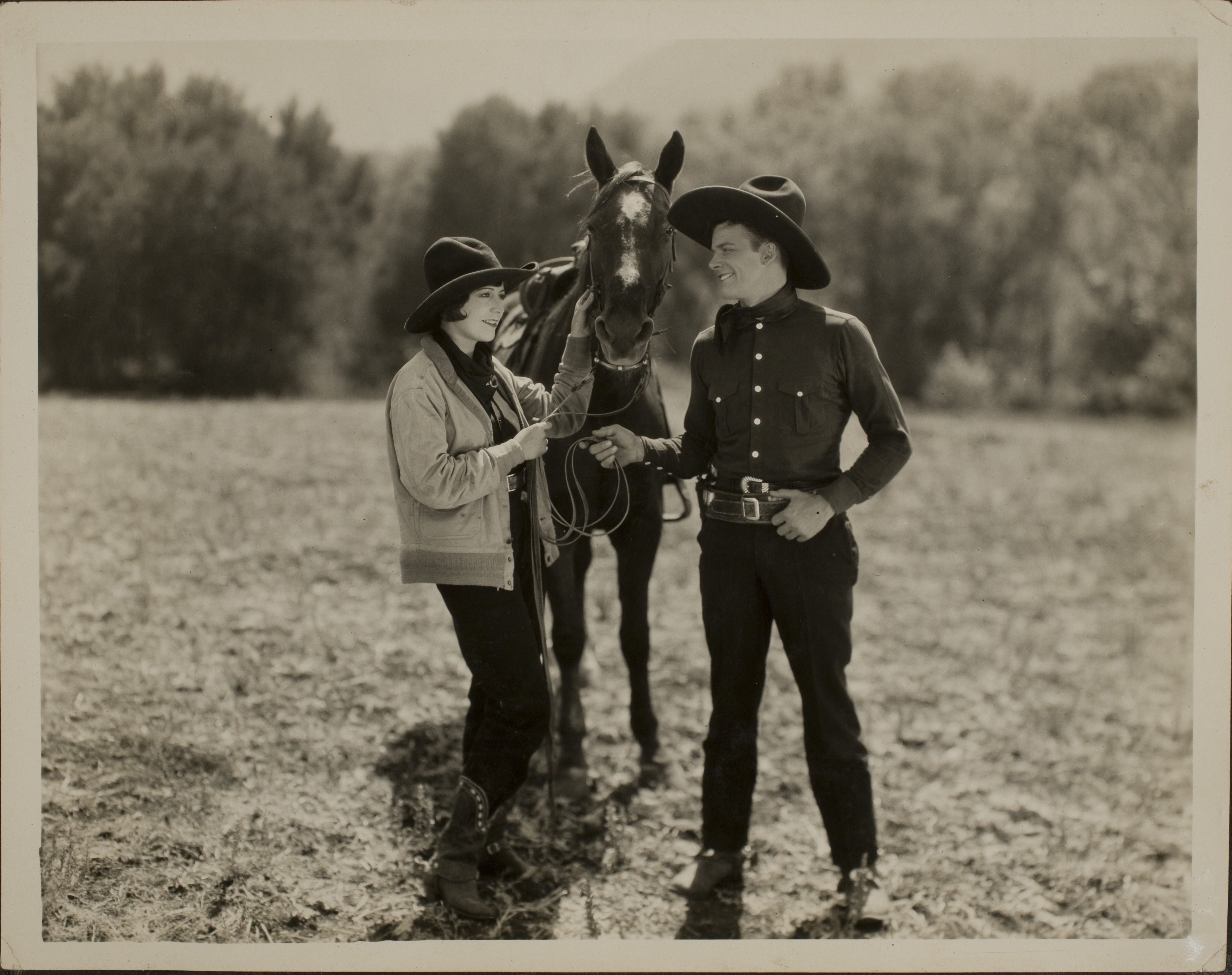 Rex Bell with unidentified woman and horse: photographic print