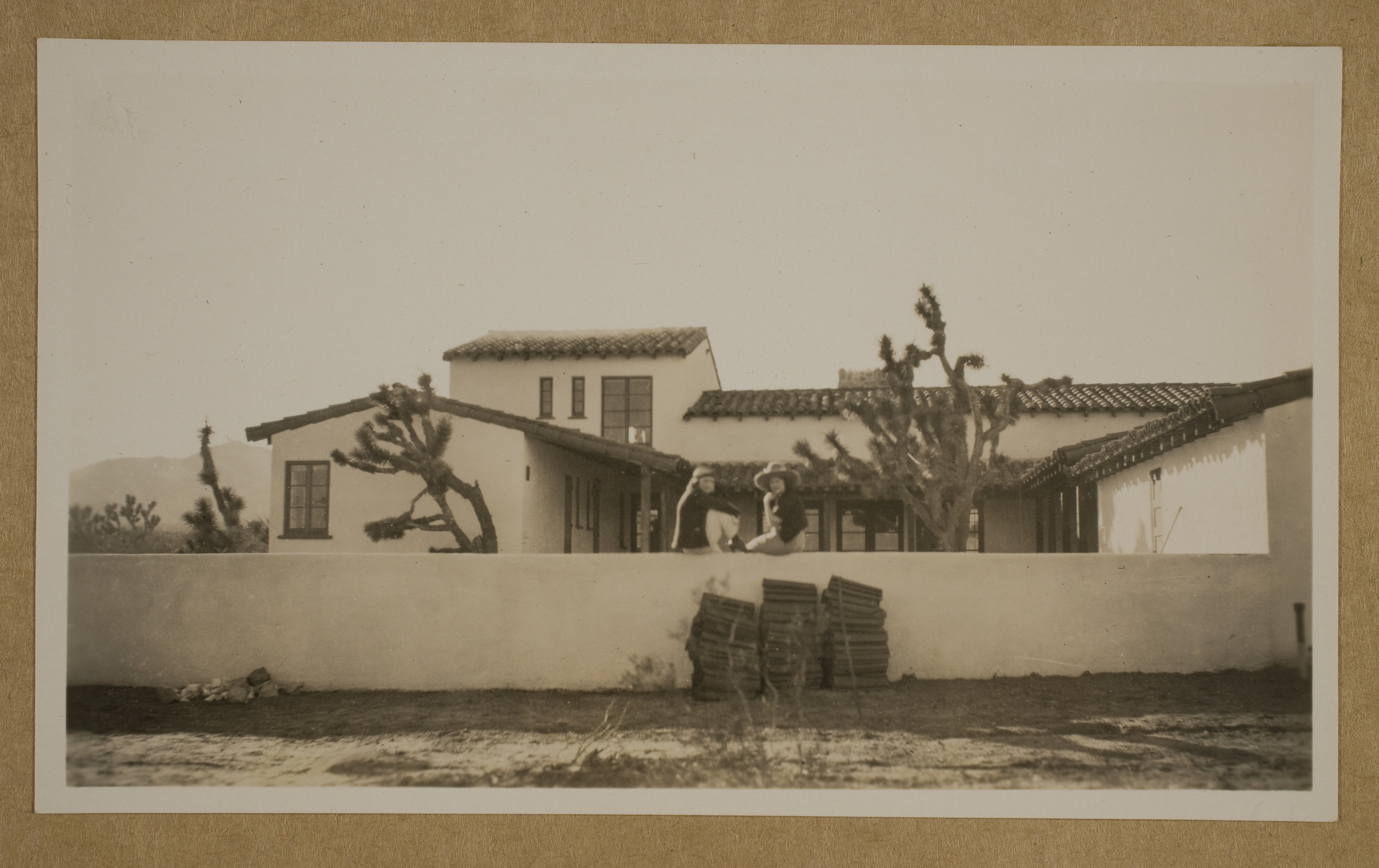 Marion Lewyn (right) and Clara Bow (left) on the wall near the pool at the ranch house at Walking Box Ranch: photographic print