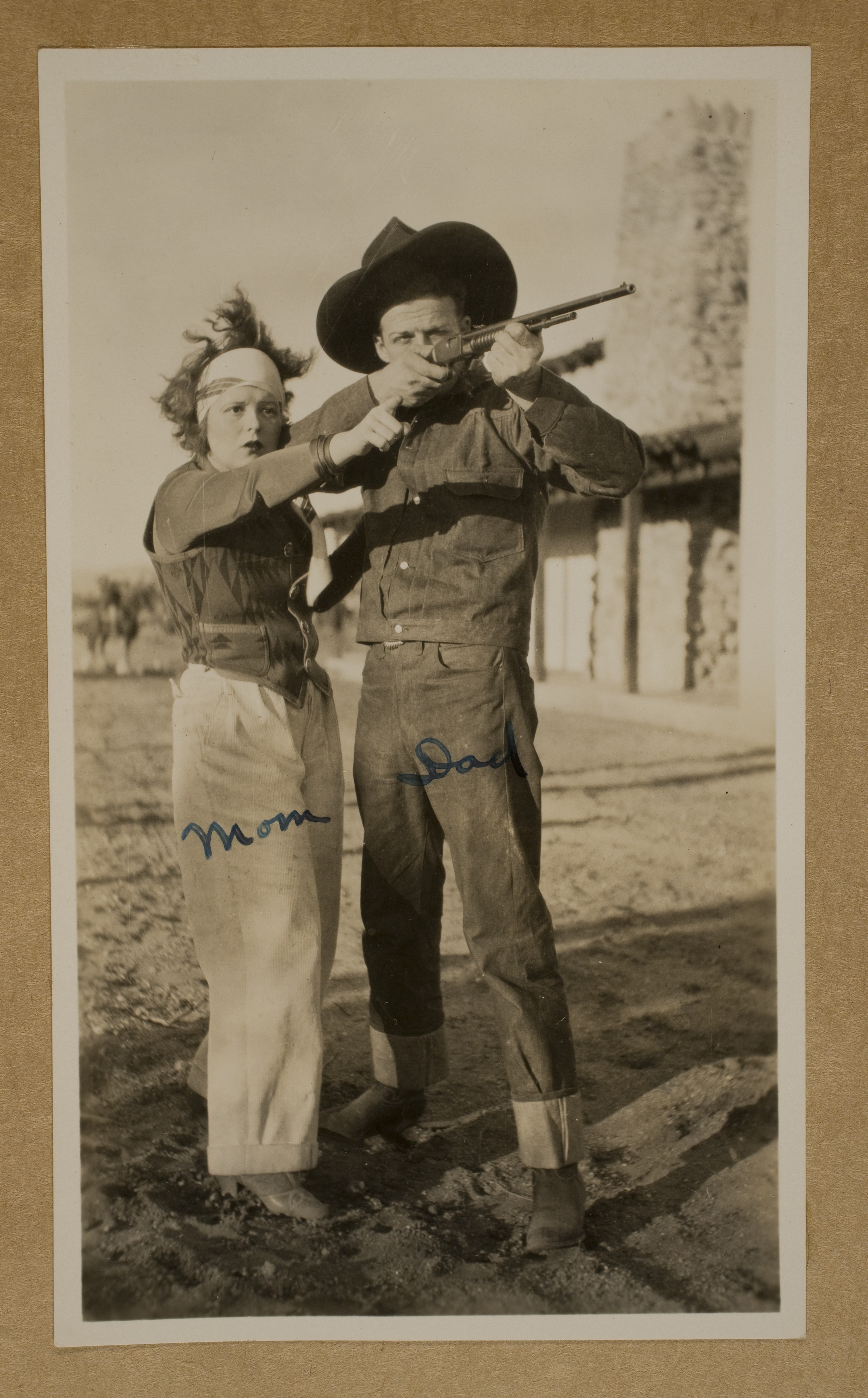 Clara Bow (left) and Rex Bell (George Francis Beldam) (right) at Walking Box Ranch.  Rex is shooting a rifle: photographic print
