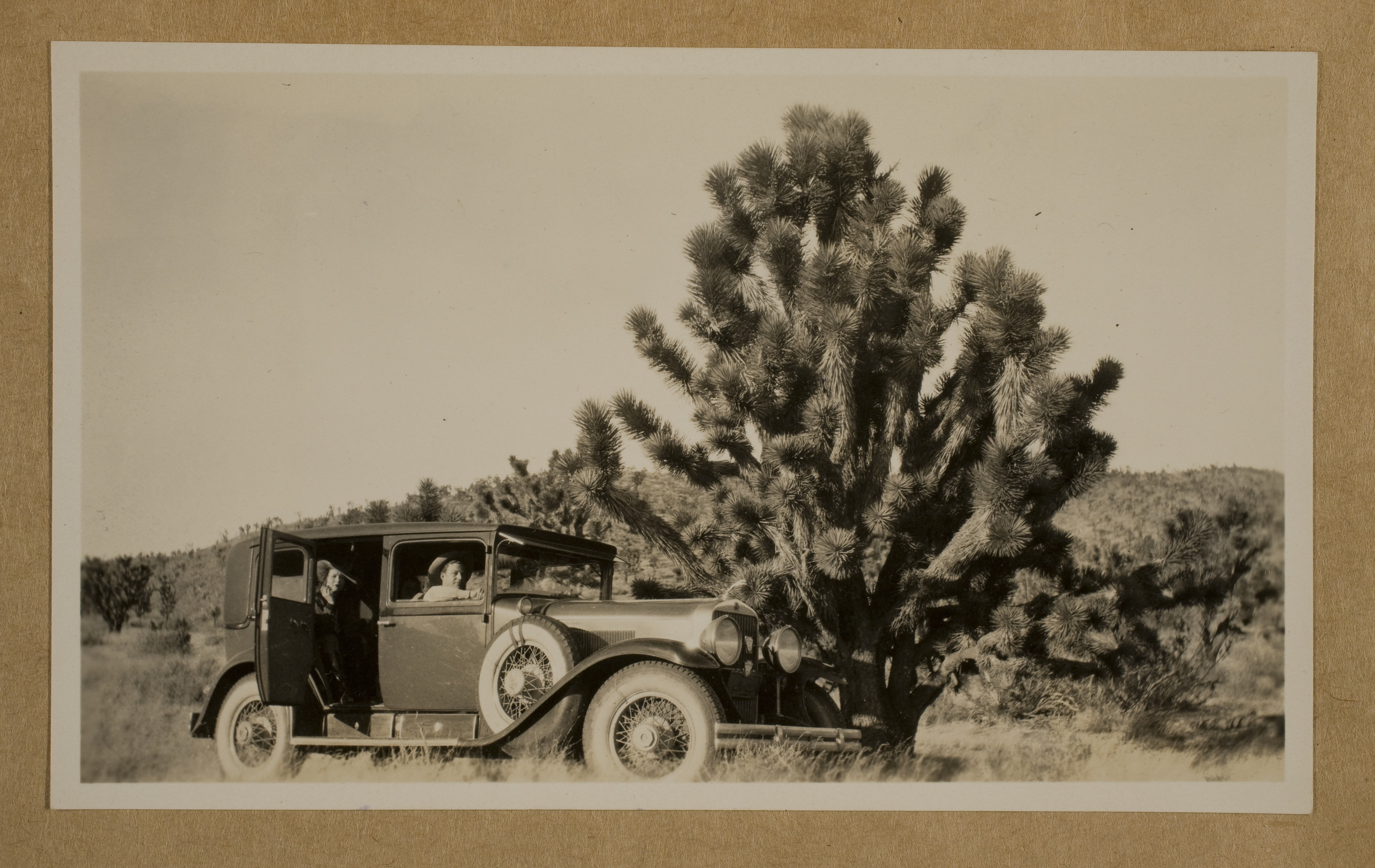 Clara Bow and  Rex Bell (George Francis Beldam) seated in a car in Mojave Desert: photographic print