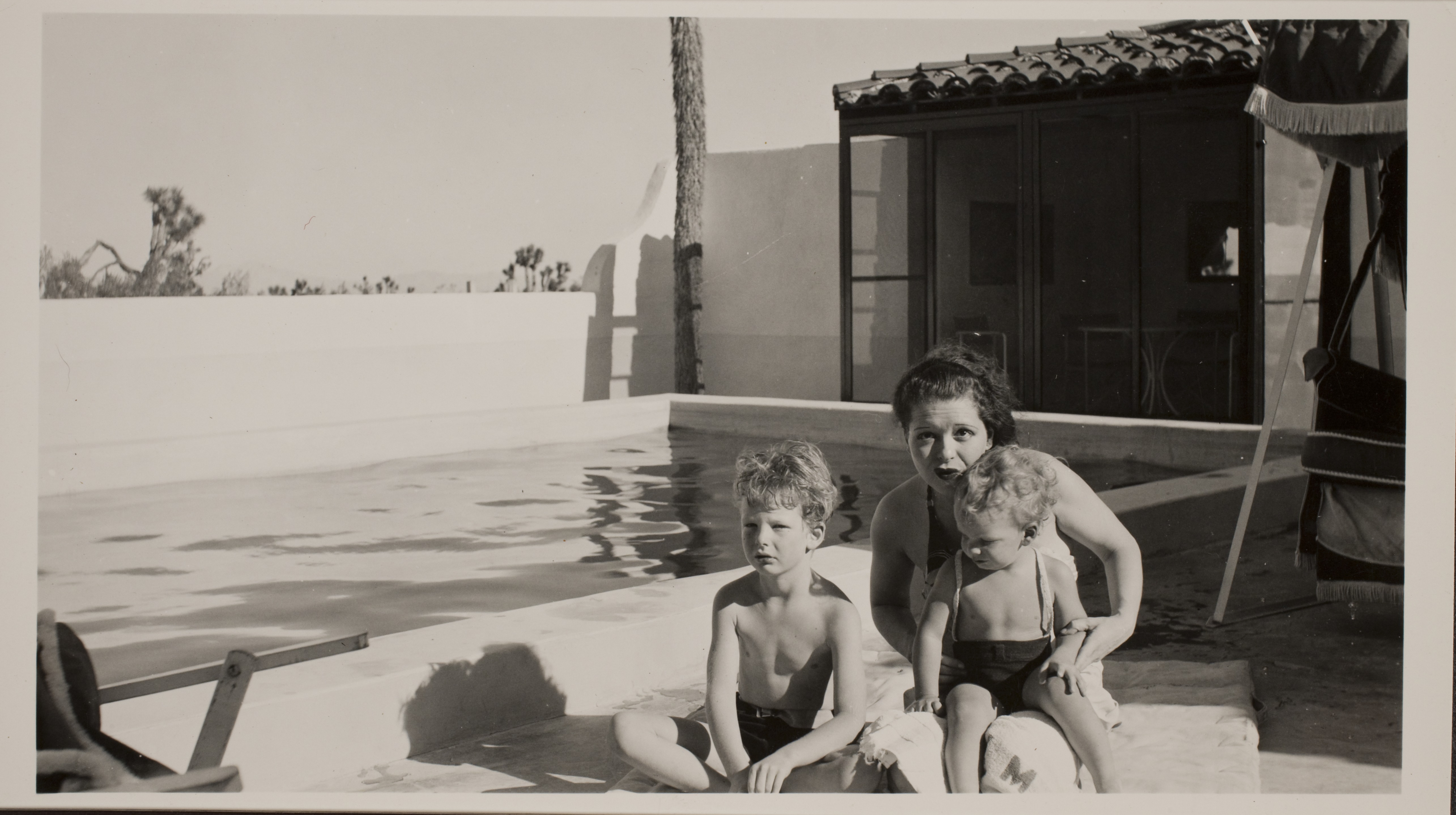 Clara Bow with Rex Jr. (Toni) on left and George on her lap near the pool at the ranch house located at the Walking Box Ranch: photographic print