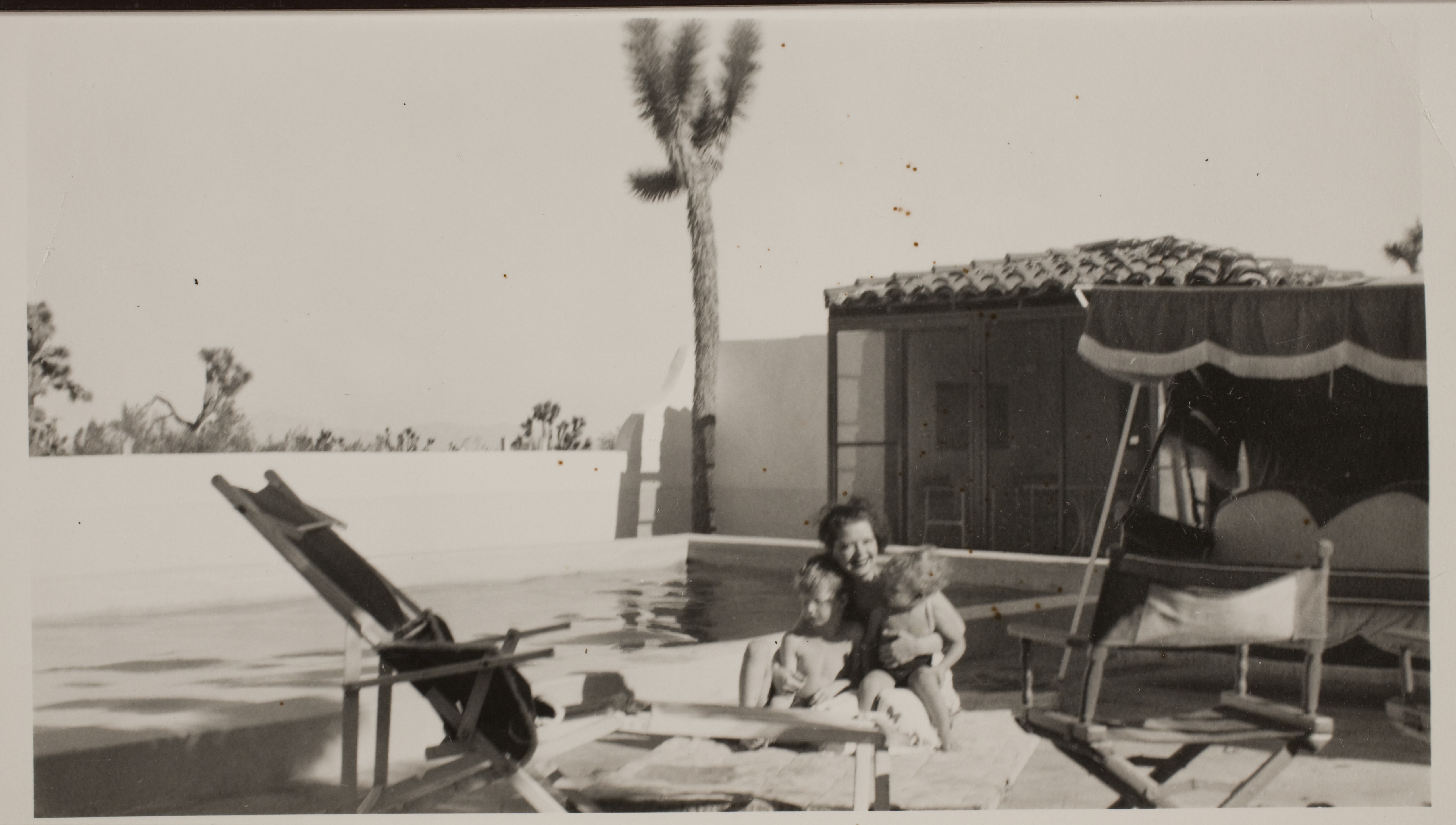 Clara Bow with Rex Jr. (Toni) on left and George on her lap near the pool at the ranch house located at the Walking Box Ranch, Nevada: photographic print