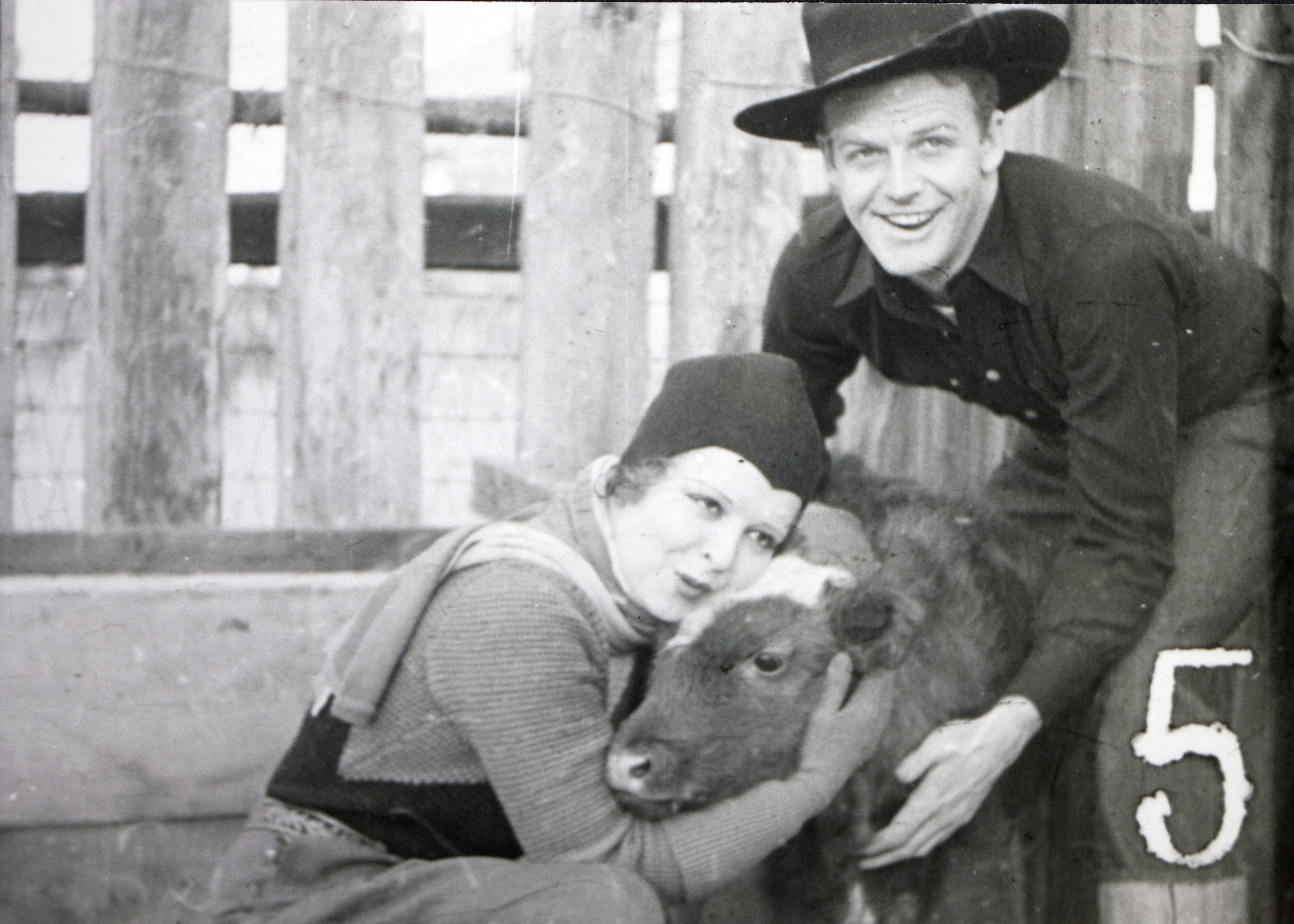 Clara Bow and  Rex Bell (George Francis Beldam) with young calf at Walking Box Ranch.  Still image from Paramounts "Hollywood on Parade". No. B-11 / Paramount. 1934: photographic print