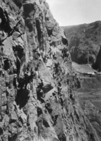 Film transparency of workers scaling the walls of the canyon, Hoover Dam, circa early 1930s