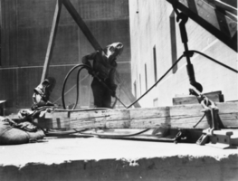 Film transparency of a worker welding on the canyon floor, Hoover Dam, circa 1930-1935