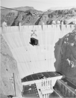 Film transparency of railroad boxcar being lowered into Hoover Dam, circa early 1930s