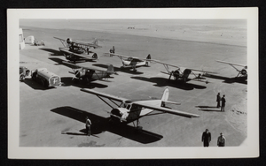 Photograph of people standing on airfield with propeller airplanes, Boulder City, Nevada, circa 1930s