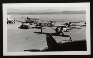 Photograph of people standing on airfield with propeller airplanes, Boulder City, Nevada, circa 1930s