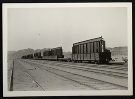 Photograph of railroad cars transporting structures to Hoover Dam, circa 1930-1935