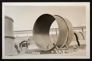 Photograph of man standing inside pipe, Hoover Dam, circa 1930-1935