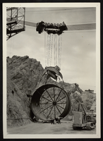 Photograph of pipe being lifted into Hoover Dam construction site, circa 1930-1935