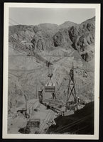 Photograph of equipment being lowered into Hoover Dam construction site, circa 1930-1935
