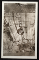 Postcard showing pipe section being cabled into Hoover Dam construction site, circa 1930-1935