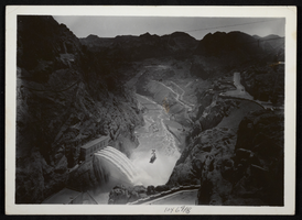 Aerial photograph showing boxcar being lowered into Hoover Dam, circa 1934-1935