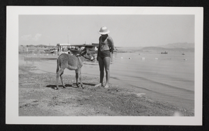 Photograph of a man and burro near Hoover Dam, circa late 1930s