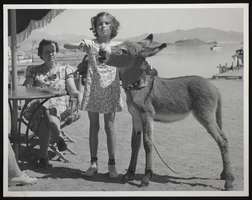 Photograph of burro and two people near Hoover Dam, circa late 1930s