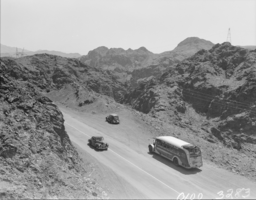 Film transparency of bus and automobiles on Kingman Higway, Kingman, Arizona, circa 1930s