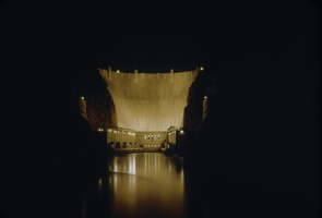 Slide of downstream face of Hoover Dam at night, circa late 1930s