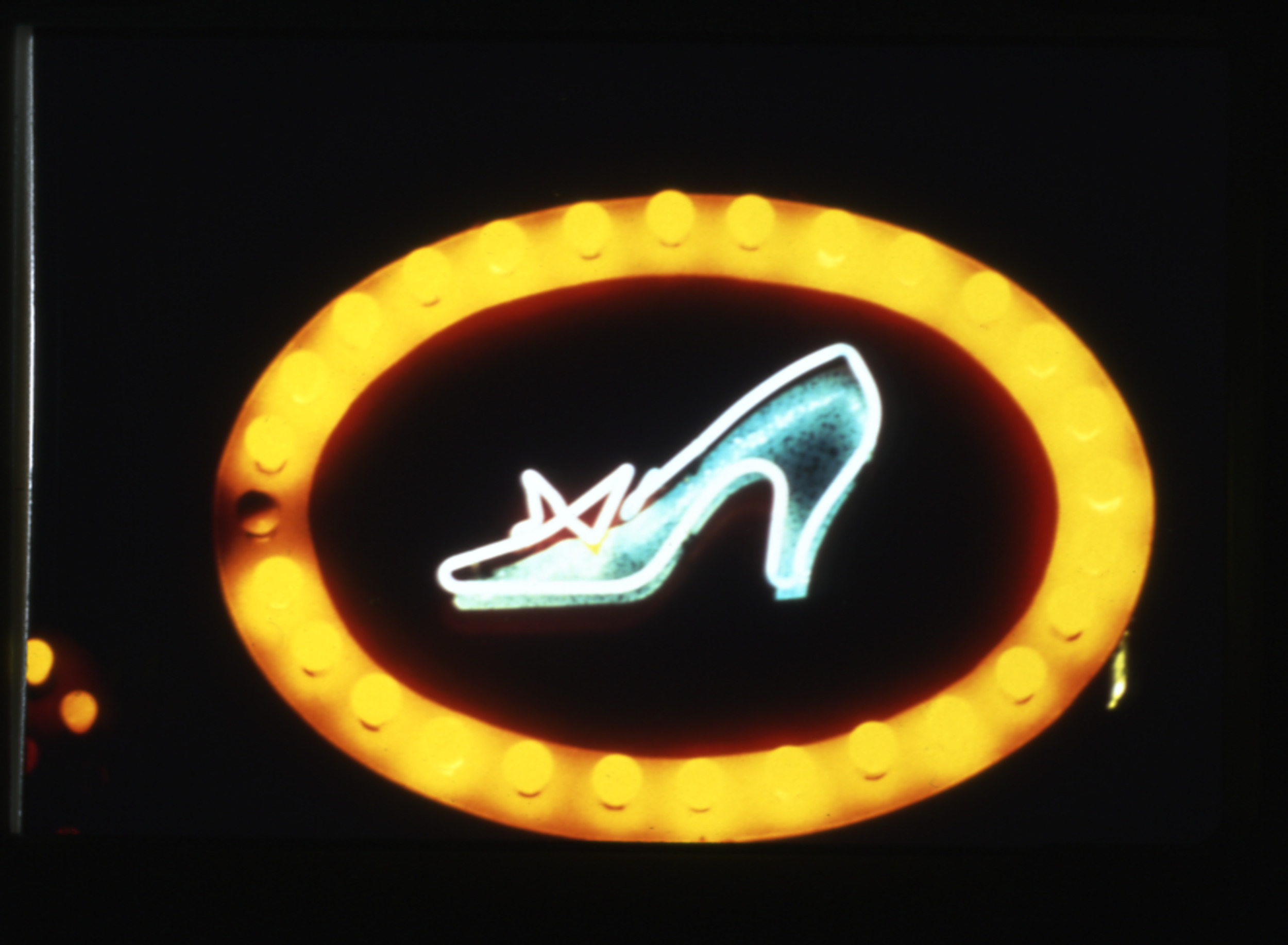 Slide of a neon sign with a woman's shoe, Las Vegas, Nevada, circa 1980s