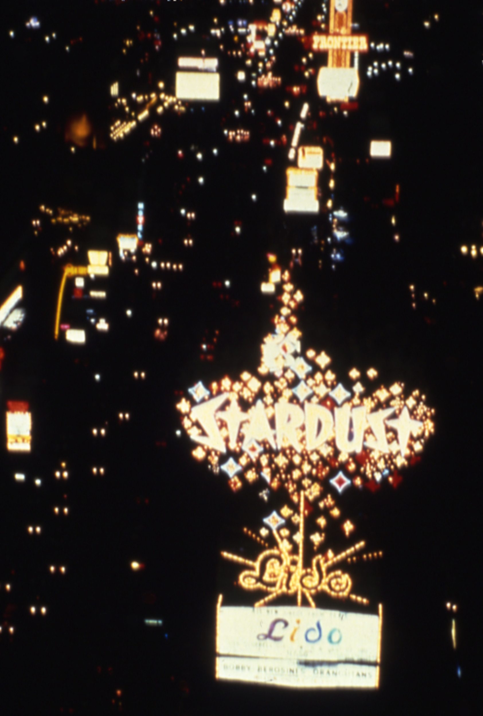 Slide of neon signs at night on Las Vegas Boulevard, circa 1980s