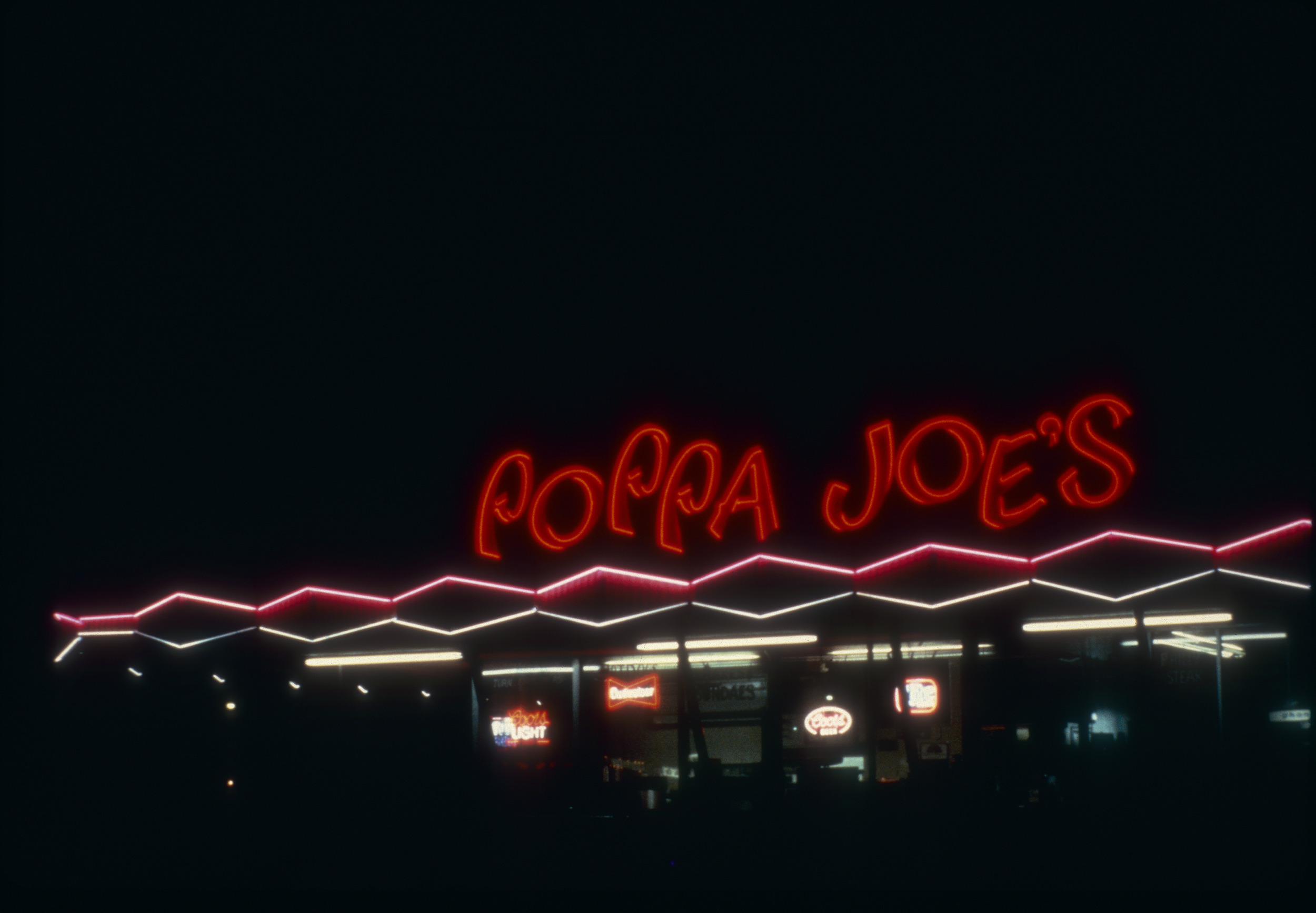 Slide of a neon sign for Poppa Joe's restaurant, Las Vegas, circa  1980s