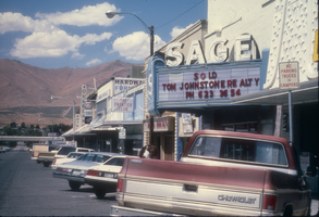 Slide of the neon signs for the Sage Theatre and other establishments on Bridge Street, Winnemucca, Nevada, 1986