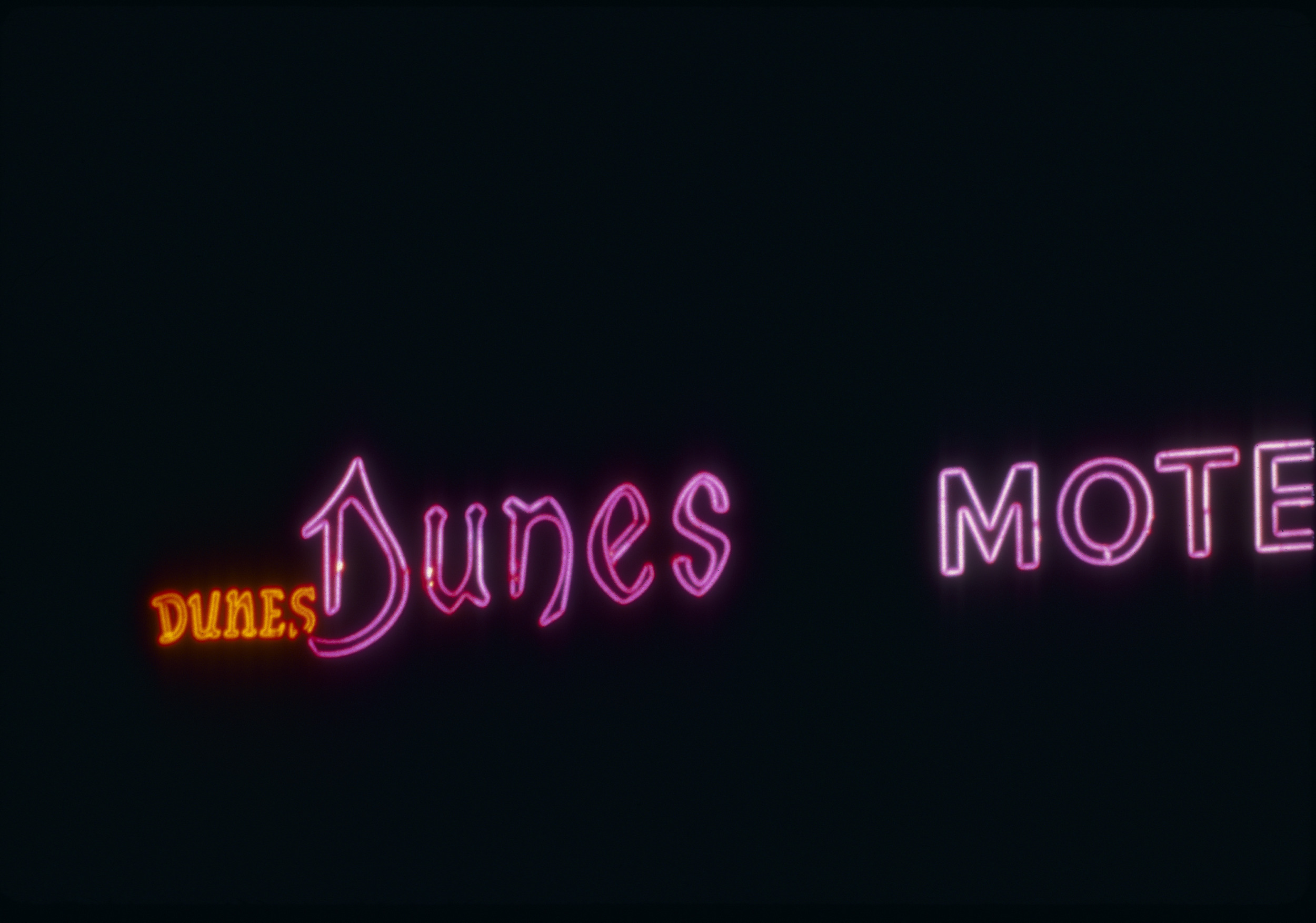 Slide of neon sign for the Dunes Motel sign, Reno, Nevada, 1986